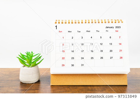 A January 2023 Monthly desk calendar for 2023 year on wooden table. 97313849