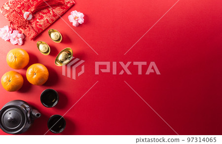 Chinese new year decorations made from red packet, orange and gold ingots or golden lump on a red background. Chinese characters FU in the article refer to fortune good luck, wealth, money flow. Chinese new year decorations made from red packet, orange and gold ingots or golden lump on a red background. Chinese characters FU in the article refer to fortune good luck, wealth, money flow. 97314065