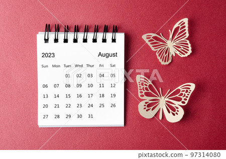 A August 2023 desk calendar for the organizer to plan and reminder with paer butterfly on red background. 97314080