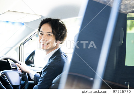 man in the driver's seat of a car man in the driver's seat of a car 97316770