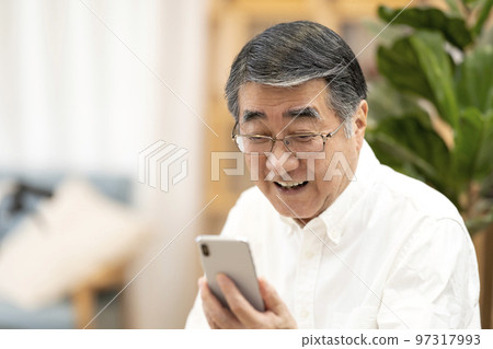 Senior man using smartphone 97317993