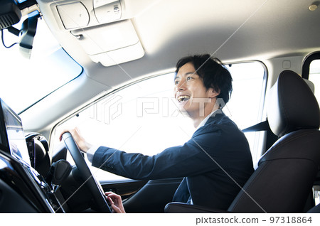 A man driving a car A man driving a car 97318864