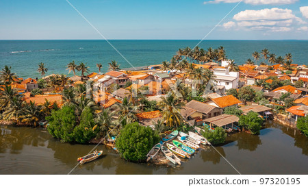 Aerial view of houses on the shoreline in Negombo. Negombo is a city on the west coast of Sri Lanka Aerial view of houses on the shoreline in Negombo. Negombo is a city on the west coast of Sri Lanka 97320195