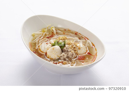 Thai style noodle in Tom Yum soup with meat ball and chicken on white background. Thai style noodle in Tom Yum soup with meat ball and chicken on white background. 97320910