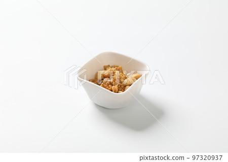 Delicious fat food, fried greaves pork in a bowl on white background. 97320937