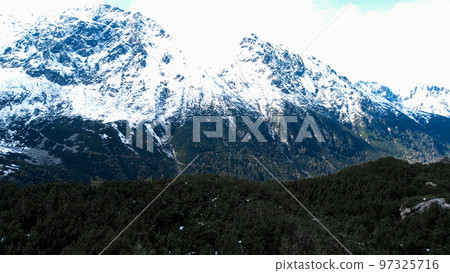 Czarny Staw pod Rysamy or Black Pond lake near the Morskie Oko Snowy Mountain Hut in Polish Tatry mountains, drone view, Zakopane, Poland. 4k Aerial view shot of beautiful green hills and mountains in 97325716