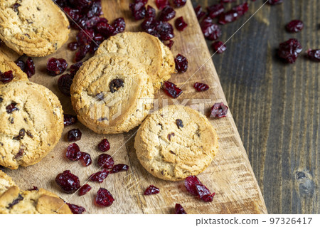 delicious dried cookies made of high-quality flour with dried red cranberries on the table delicious dried cookies made of high-quality flour with dried red cranberries on the table 97326417