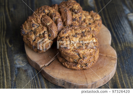 Delicious cookies with pieces of chocolate on the table Delicious cookies with pieces of chocolate on the table 97326420