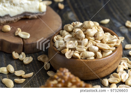 Peeled and roasted peanuts on the table 97326603