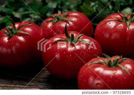 large juicy tomatoes on a wooden board. 97326693
