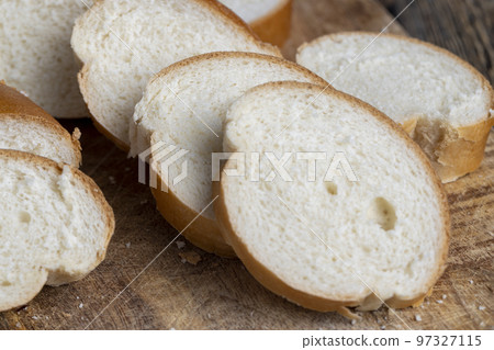 Sliced wheat loaf on the table Sliced wheat loaf on the table 97327115