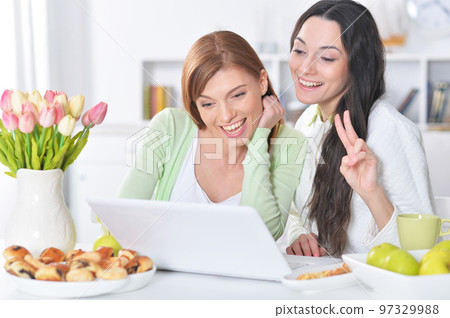 two female friends at desk two female friends at desk 97329988