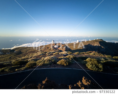 Convertible car driving over Roque de los Muchachos road 97330122