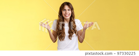 Angry freaked out disappointed woman frowning grimacing anger distress raise hands sideways full dismay complaining being rude arguing look pissed outraged swearing frustrated yellow background Angry freaked out disappointed woman frowning grimacing anger distress raise hands sideways full dismay complaining being rude arguing look pissed outraged swearing frustrated yellow background 97330225
