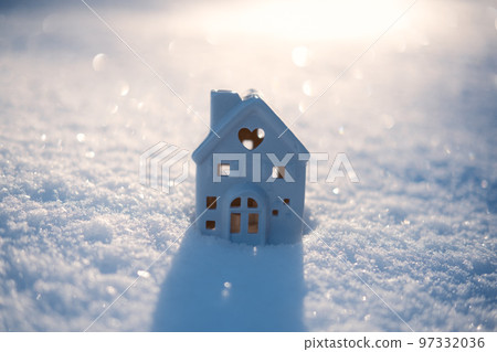 Winter solstice in snowy forest or park natural scene. Hibernal solstice. Toy house and Sparkling snow in the snowy forest and low sun Winter solstice in snowy forest or park natural scene. Hibernal solstice. Toy house and Sparkling snow in the snowy forest and low sun 97332036