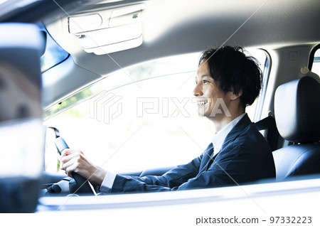 A man driving a car A man driving a car 97332223