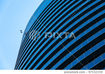 Birds flying over modern skyscraper Birds flying over modern skyscraper 97332339