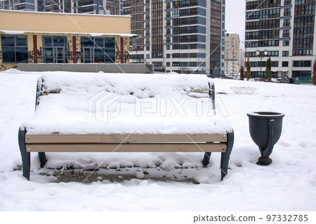 Wooden bench under the snow in the park Wooden bench under the snow in the park 97332785