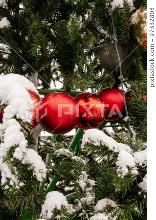 Red balls on a street Christmas tree 97332803