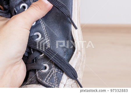 Old torn shoe in hands of man Old torn shoe in hands of man 97332883