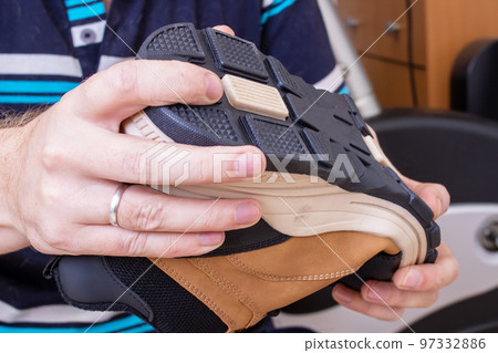 Brown shoe in the hands of a man Brown shoe in the hands of a man 97332886