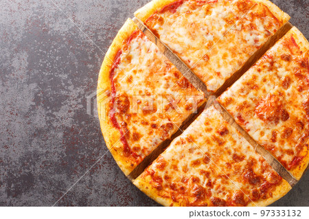 Delicious crispy New York style pizza with melted cheese and base tomato sauce close-up on a wooden board. Horizontal top view Delicious crispy New York style pizza with melted cheese and base tomato sauce close-up on a wooden board. Horizontal top view 97333132