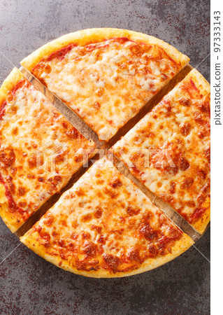 Hot fresh New York Style Pizza with marinara sauce and topped with mozzarella cheese on the board. Vertical top view Hot fresh New York Style Pizza with marinara sauce and topped with mozzarella cheese on the board. Vertical top view 97333143