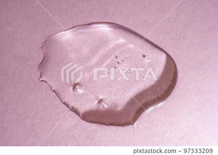 A drop of transparent cosmetic gel on a pink background A drop of transparent cosmetic gel on a pink background 97333209