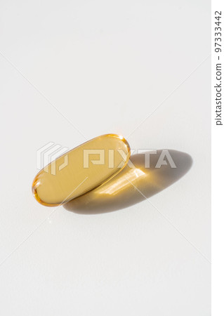 Oil filled capsules on the white background Oil filled capsules on the white background 97333442