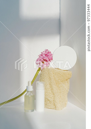 Cream, serum and natural loofah sponge on a light background. Cream, serum and natural loofah sponge on a light background. 97333444