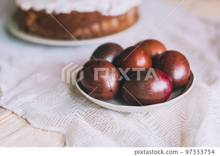 Easter table with traditional Easter cakes and Easter eggs with blossoming tree branch Easter table with traditional Easter cakes and Easter eggs with blossoming tree branch 97333754