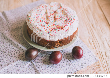 Easter table with traditional Easter cakes and Easter eggs with blossoming tree branch 97333763