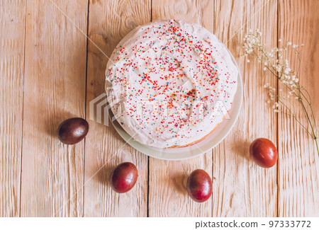 Easter table with traditional Easter cakes and Easter eggs with blossoming tree branch 97333772