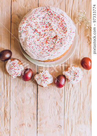 Easter table with traditional Easter cakes and Easter eggs with blossoming tree branch Easter table with traditional Easter cakes and Easter eggs with blossoming tree branch 97333774