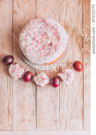 Easter table with traditional Easter cakes and Easter eggs with blossoming tree branch Easter table with traditional Easter cakes and Easter eggs with blossoming tree branch 97333775