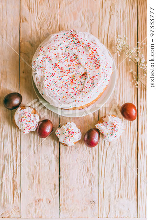 Easter table with traditional Easter cakes and Easter eggs with blossoming tree branch Easter table with traditional Easter cakes and Easter eggs with blossoming tree branch 97333777