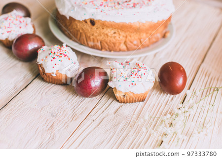Easter table with traditional Easter cakes and Easter eggs with blossoming tree branch Easter table with traditional Easter cakes and Easter eggs with blossoming tree branch 97333780