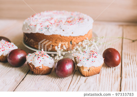 Easter table with traditional Easter cakes and Easter eggs with blossoming tree branch 97333783