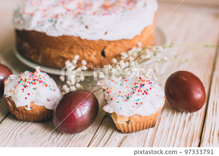Easter table with traditional Easter cakes and Easter eggs with blossoming tree branch 97333791