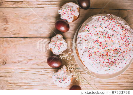 Easter table with traditional Easter cakes and Easter eggs with blossoming tree branch Easter table with traditional Easter cakes and Easter eggs with blossoming tree branch 97333798