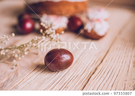 Easter table with traditional Easter cakes and Easter eggs with blossoming tree branch Easter table with traditional Easter cakes and Easter eggs with blossoming tree branch 97333807
