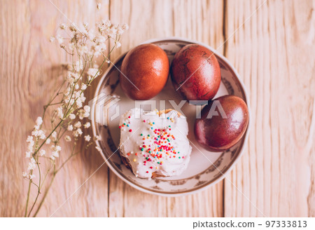 Easter table with traditional Easter cakes and Easter eggs with blossoming tree branch 97333813