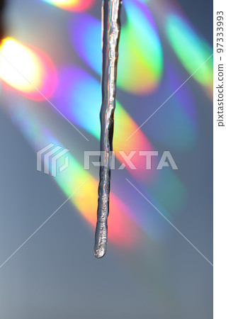icicles are melting in colorful light 97333993