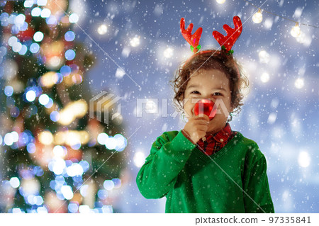Child with reindeer nose and antlers on Christmas 97335841