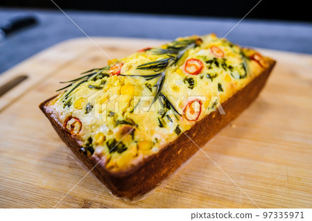 Freshly baked cornbread with red chili peppers. Defocused 97335971