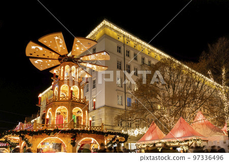 Beautiful traditional German Christmas Market square in Magdeburg city center Germany with Christmas Pyramide many carousel, tree lights and decoration. Christmas and new year celebration season 97336496