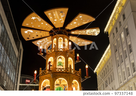 Beautiful traditional German Christmas Market square in Magdeburg city center Germany with Christmas Pyramide many carousel, tree lights and decoration. Christmas and new year celebration season 97337148
