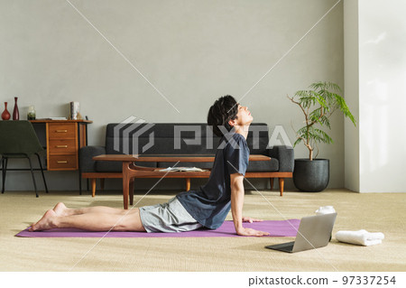 Man stretching his waist at home 97337254