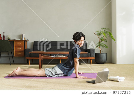 Man stretching his waist at home 97337255