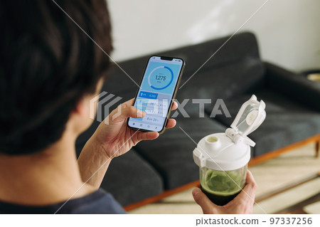 A man using a health management app A man using a health management app 97337256